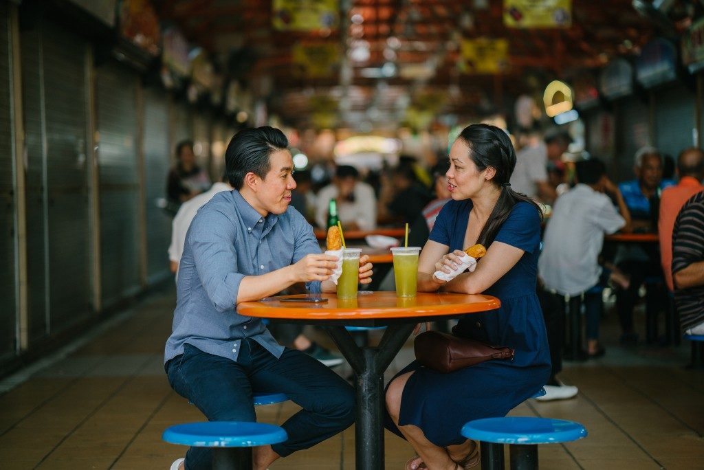 couple dining in hawker place in Singapore